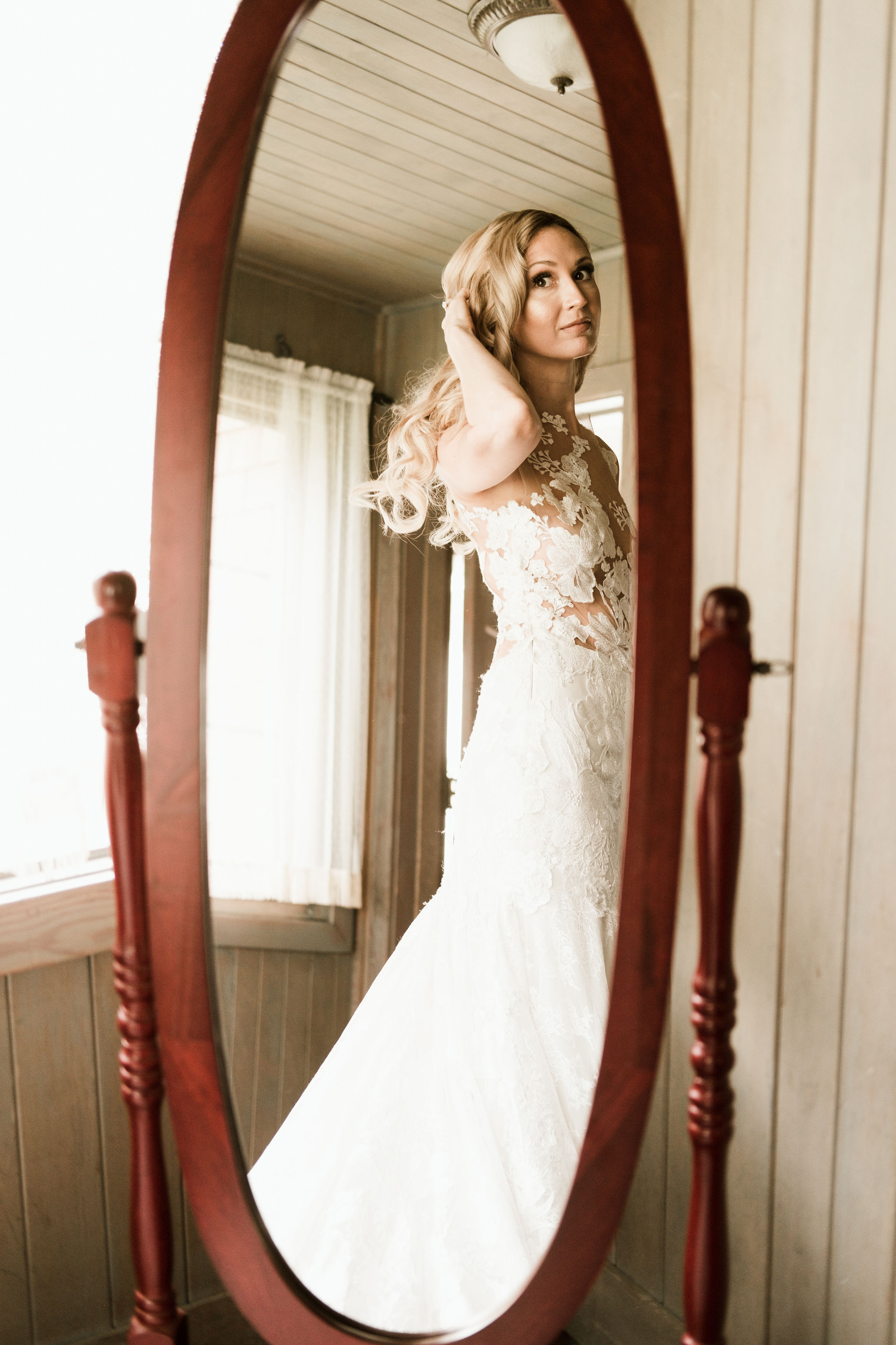 Bride looking at herself in the mirror