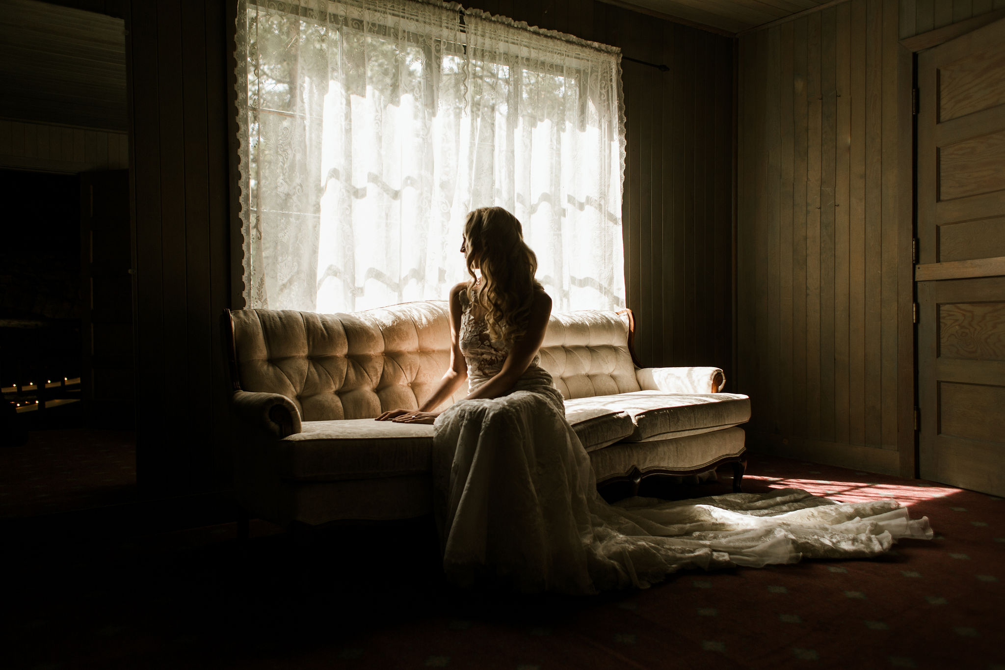 Bride sitting by a window on her wedding day in Lake Tahoe